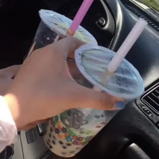 a person holding a drink in their hand