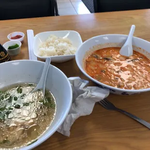 two bowls of soup and rice on a table