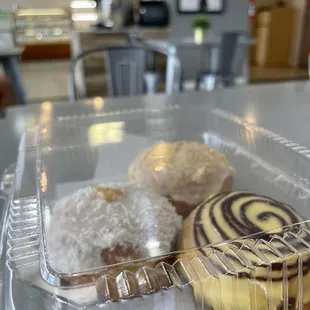a variety of pastries in a plastic container