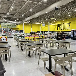 empty tables and chairs in a grocery store