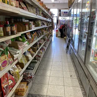 a grocery store aisle with food on the shelves