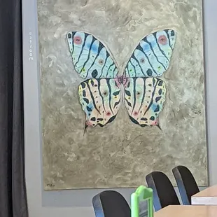 a painting of a butterfly on a wall