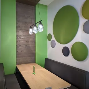 a modern dining room with green accents