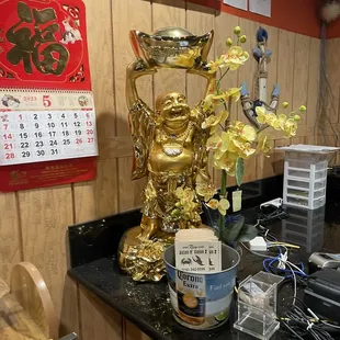 Gold Buddha at front register.