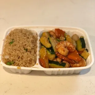 a container of rice, vegetables, and shrimp