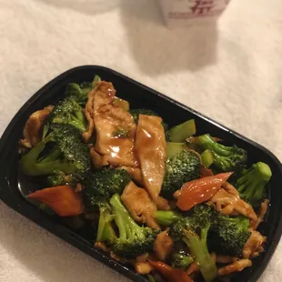chicken and broccoli in a black container