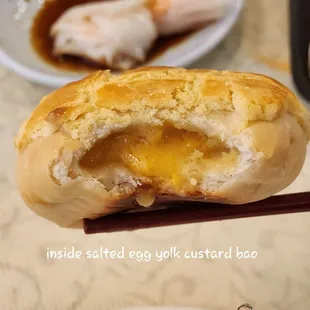 a person holding a piece of bread with a bite taken out of it