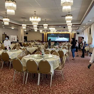 tables and chairs with white tablecloths