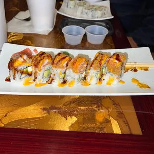 a plate of sushi and chopsticks