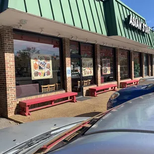 cars parked in front of a restaurant