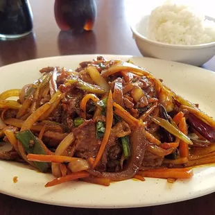 Dinner portion of Szechuan beef with steamed rice.