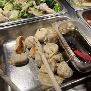 a tray of dumplings and broccoli