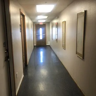 a long hallway leading to a door
