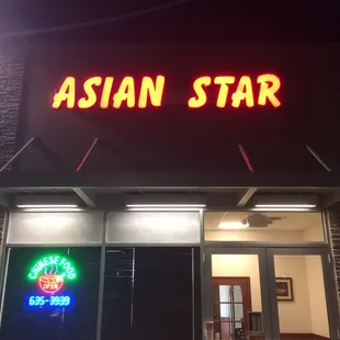 a neon sign on the front of a restaurant