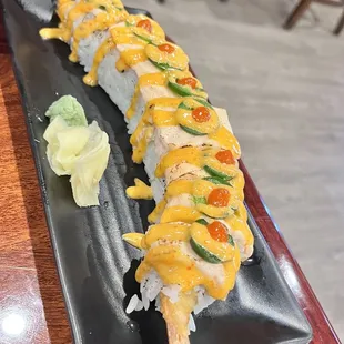 a sushi roll on a black plate