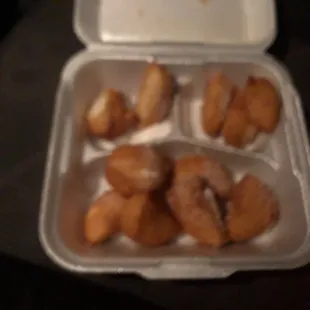 a container of donuts with a lid