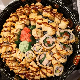 a plate of sushi and rolls