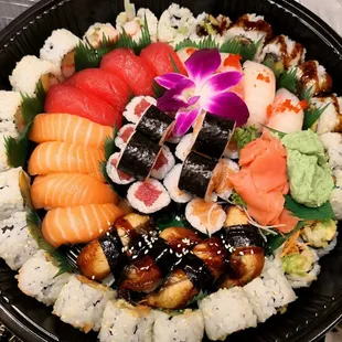 a plate of sushi and rolls