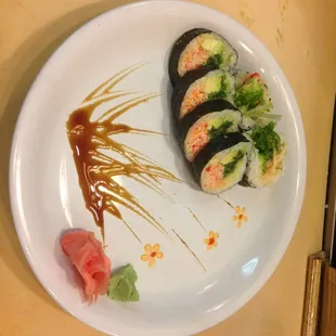 a plate of sushi with sauce on it