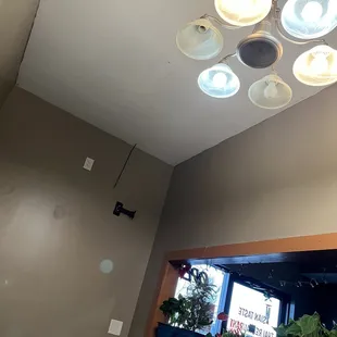My private, 3-table, coat closet dining area with 4/7 bulbs functioning on chandelier.
