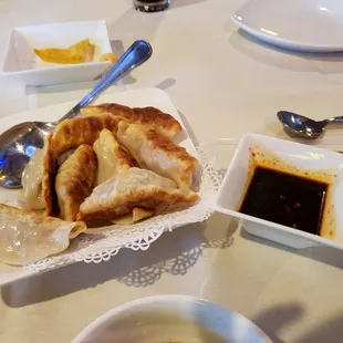 a plate of dumplings and dipping sauce