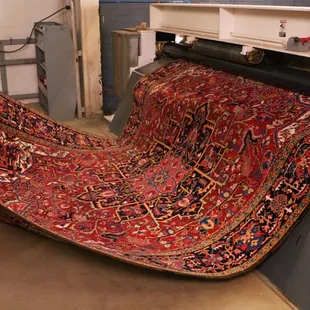 Expert Rug Cleaning - a rug going through our state of the art wringer to dry them quickly and efficiently.