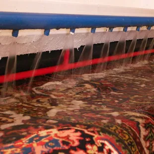 Expert Rug Cleaning - a rug going through our state of the art wringer for a final rinse.