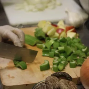 a person chopping vegetables on a cutting board