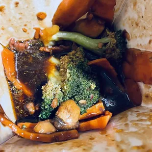 a burrito with broccoli and other vegetables