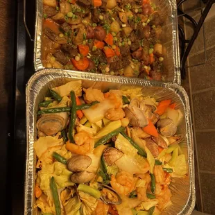 two pans of food on a stove