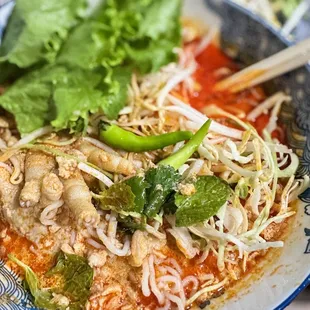 a plate of noodles with meat and vegetables