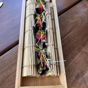 a sushi dish on a bamboo tray