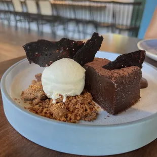 flourless chocolate cake with vanilla ice cream and crumbled cookies