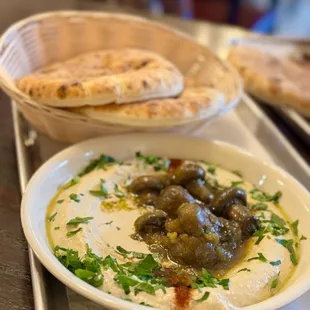 a bowl of olives and pita bread