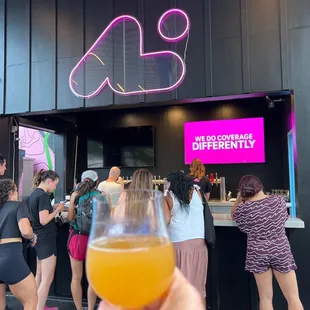 a hand holding a glass of orange juice