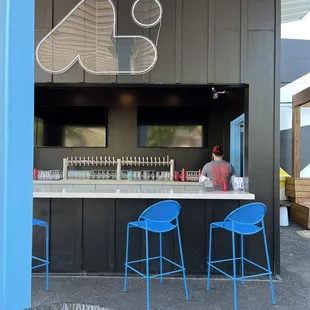 a bar with blue chairs