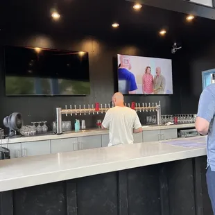 two men standing at the bar