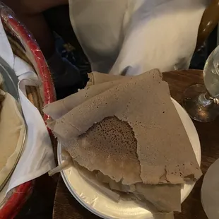 a plate of pita bread and a glass of wine