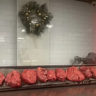 a tray of raw meat on a counter