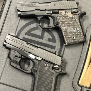 Sig Sauer P938 Extreme (Top) Sig Sauer P938 Laser (Bottom)