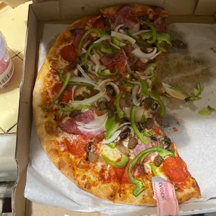 a half eaten pizza in a box