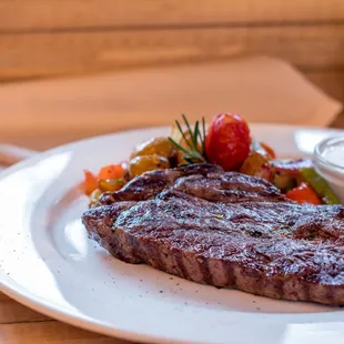 a steak with a side of vegetables
