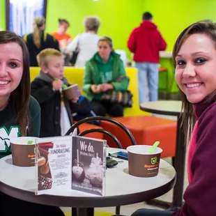 two women sitting at a table