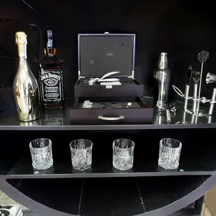 liquor bottles and glasses on a shelf