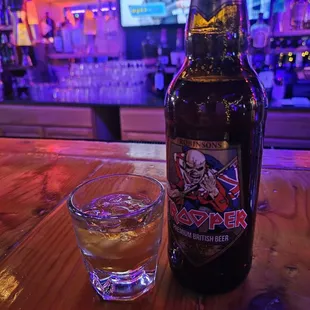 a bottle of beer and a shot glass