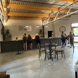 a group of people sitting at tables in a large open space