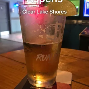 a glass of beer on a coaster