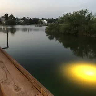 a bench on a dock overlooking a lake