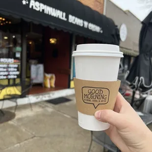 hand holding a cup of coffee