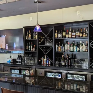 a bar with many bottles of alcohol